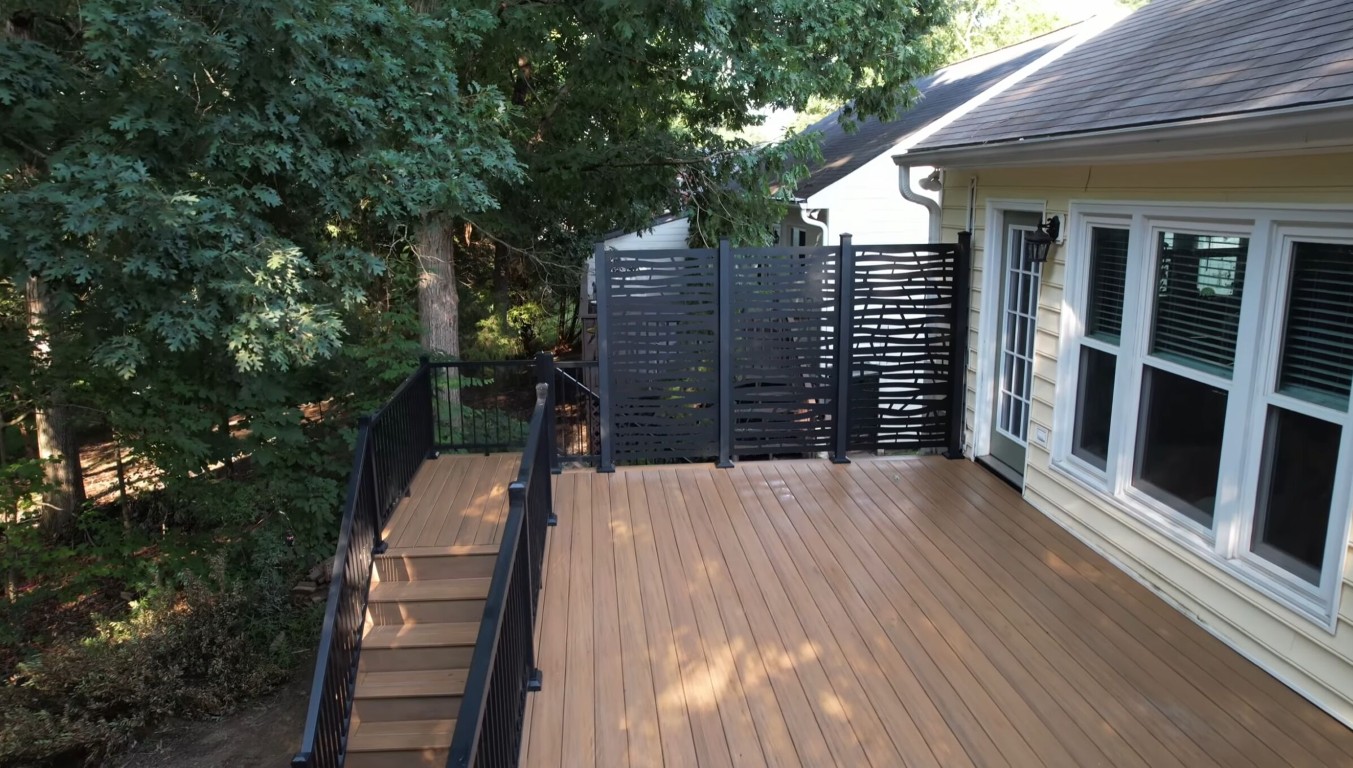 Custom deck with privacy screens and black railings in Oxnard, CA